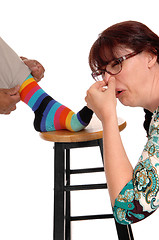 Image showing Woman smells the feet of husband.