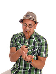 Image showing Hispanic man try to light his cigar.