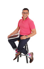 Image showing Smiling Hispanic man sitting on chair. 