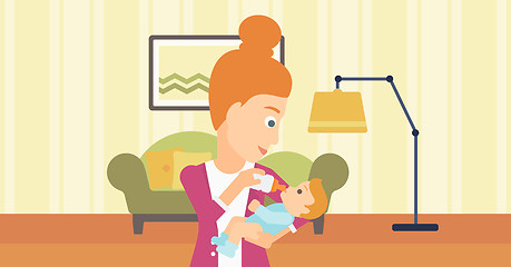 Image showing Woman feeding baby.