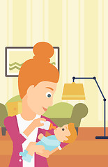 Image showing Woman feeding baby.