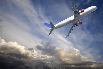 Image showing Plane escape from dark thunder clouds