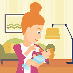 Image showing Woman feeding baby.