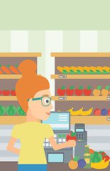 Image showing Cashier at supermarket checkout.