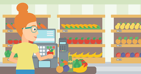 Image showing Cashier at supermarket checkout.