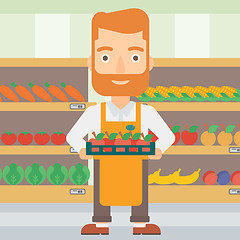 Image showing Supermarket worker with box full of apples.