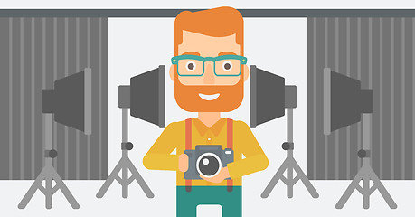 Image showing Smiling photographer holding camera.