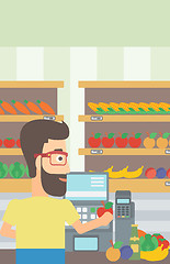 Image showing Cashier at supermarket checkout.