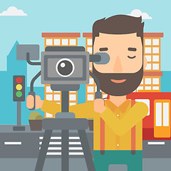 Image showing Cameraman with movie camera on a tripod.