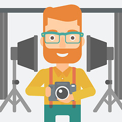 Image showing Smiling photographer holding camera.