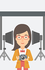 Image showing Smiling photographer holding camera.