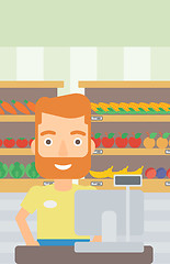 Image showing Salesman standing  at checkout.