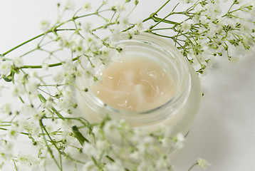 Image showing face creme and white flowers