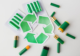 Image showing close up of batteries and green recycling symbol