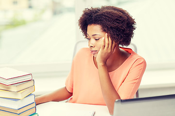 Image showing bored african american woman doing homework home