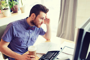 Image showing creative male worker with computer drinking coffee