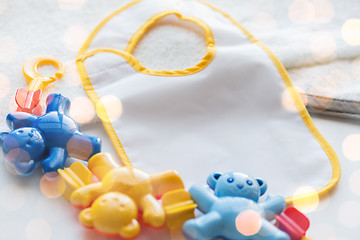 Image showing close up of baby rattle and bib for newborn