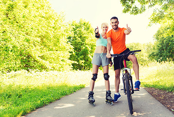 Image showing couple on rollerblades and bike showing thumbs up