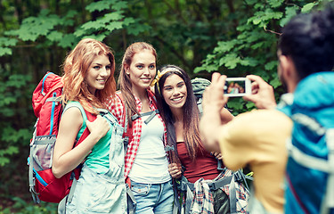 Image showing friends with backpack photographing by smartphone