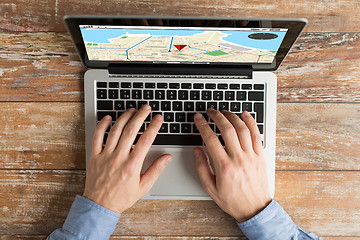 Image showing close up of male hands with laptop typing