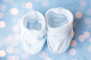 Image showing close up of baby bootees for newborn boy on blue