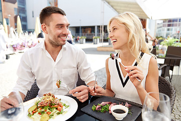 Image showing happy couple eating dinner at restaurant terrace