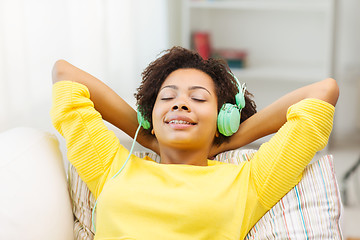 Image showing happy woman with headphones listening to music