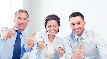 Image showing business team showing thumbs up in office