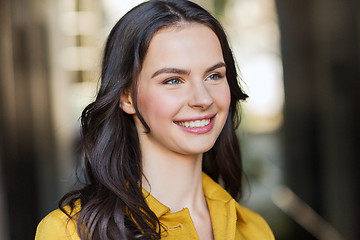 Image showing smiling young woman in city