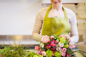 Image showing close up of woman making bunch at flower shop