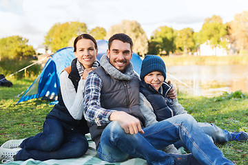 Image showing happy family with tent at camp site