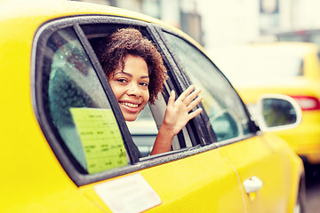 Image showing happy african american woman driving in taxi