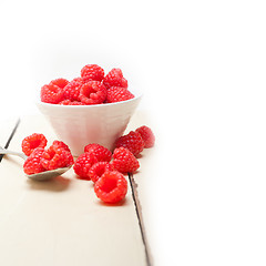 Image showing bunch of fresh raspberry on a bowl and white table