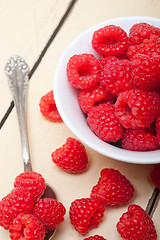 Image showing bunch of fresh raspberry on a bowl and white table