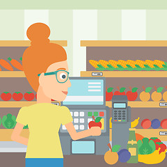 Image showing Cashier at supermarket checkout.