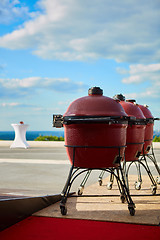 Image showing Three kettle barbecue grill with cove