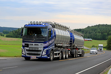 Image showing New Blue Volvo Tank Truck on Scenic Road at Summer