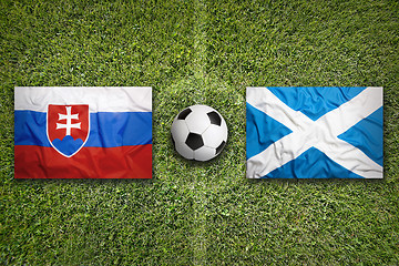 Image showing Slovakia vs. Scotland flags on soccer field