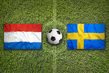 Image showing Netherlands vs. Sweden flags on soccer field