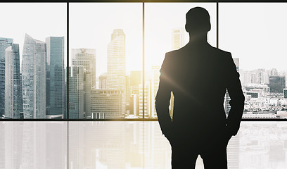 Image showing silhouette of business man over office background