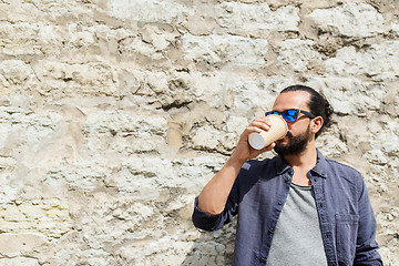 Image showing man drinking coffee from paper cup on street