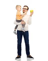 Image showing happy father and little son with green apple