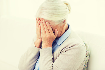 Image showing senior woman suffering from headache or grief