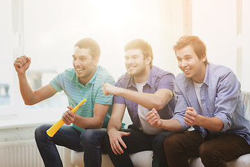 Image showing happy male friends with vuvuzela watching sports