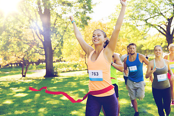 Image showing happy young female runner winning on race finish