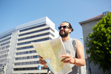 Image showing man traveling with backpack and map in city