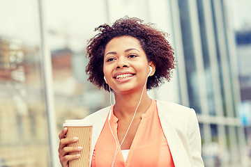 Image showing happy african businesswoman with coffee in city