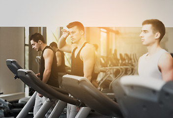 Image showing group of men exercising on treadmill in gym