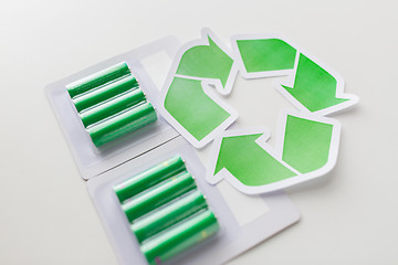 Image showing close up of batteries and green recycling symbol