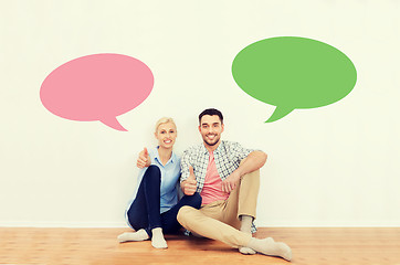 Image showing happy couple showing thumbs up at new home